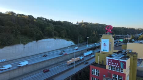 Traffic-flowing-across-Interstate-5,-revealing-the-Old-Rainier-Brewery-in-Seattle,-WA,-aerial