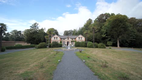 wide-dolly-forward-shot-of-Orangerie-building-at-Chateau-du-Perron,-Normandy