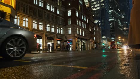 Aston-martin-car-drives-past-in-wet-rainy-central-London-evening