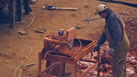 The-workers-cleans-the-cutting-equipment-on-the-construction-site