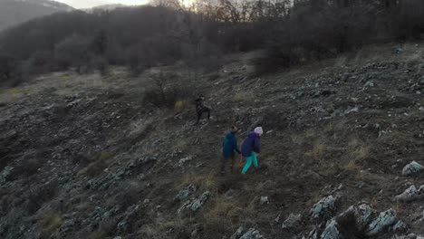 Children-play-on-edge-of-cliff---aerial-panning-shot