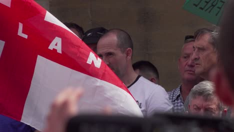 A-Tommy-Robinson-supporter-watches-the-event-outside-the-BBC-studio-in-London