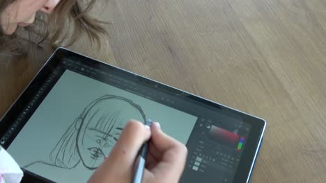 Chica-Concentrada-Dibujando-En-Una-Tableta-Gráfica