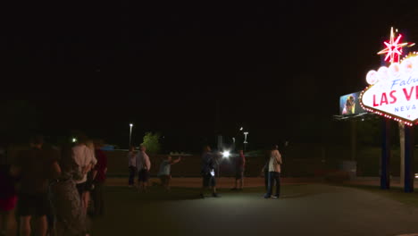 Panning-Time-Lapse-of-Tourists-Taking-Photos-in-Front-of-the-“Welcome-to-Las-Vegas”-Sign-at-Night