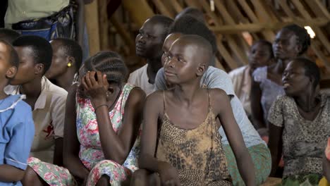 A-group-of-children-sitting-on-a-bench-looking-around-in-a-community-center-in-Africa