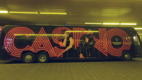 Editorial,-view-of-casino-bus,-black-bus-labeled-and-decorated-with-casino-banner-label,-shuttle-bus-from-downtown-to-the-casino-in-Montreal