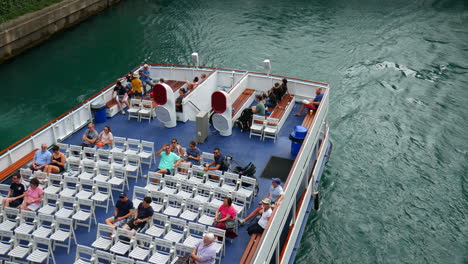 Tourists-boat-on-river,-downtown-Chicago,-Usa,-United-States,-riverwalk,-view-from-above-the-bridge,-aerial-view-of-a-river-tour-cruise-boat,-vacation-and-travel-during-summer-time