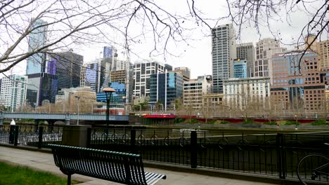 Melbourne-tourists-walking-yarra-riverside-walking-Queens-Bridge-in-daytime