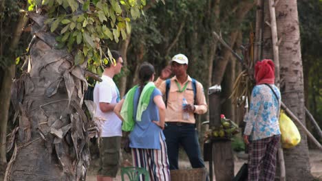 Medium-Exterior-Shot-of-Tour-Guide-Talking-About-Palm-Juice-to-Tourists