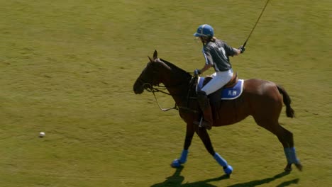 Atlanta,-GA---July-21,-2019:-A-cinematic-shot-of-a-female-polo-player-leisurely-hitting-a-forward-pass-in-slow-motion-on-a-sunny-summer-morning-during-an-Atlanta-polo-club-match