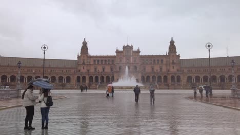 Tourists-visit-Plaza-de-Espana-on-rainy-day,-Seville,-Spain,-Slow-Motion-Static