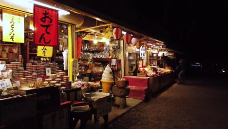 Close-pan-shot-as-steam-rises-from-boiled-vegetables-and-soups-with-tourists-walking-past