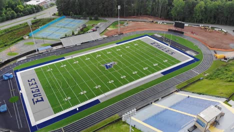 football-field-eagles-etowah-high-school-summer-practice-woodstock-georgia-aerial-drone-tilt