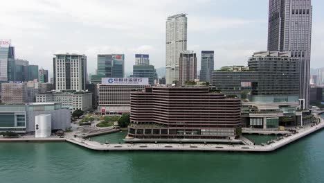 Hong-Kong-culture-centre,-Tsim-Sha-Tsui-pier-and-skyscrapers,-Aerial-view