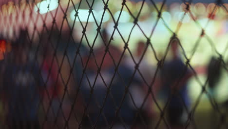 Young-boy-in-blurred-background-playing-speed-pitch-game-at-carnival,-Slow-Motion