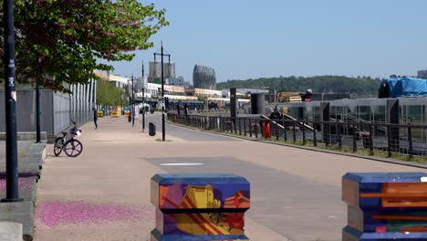 Sidewalk-aside-from-Cité-du-Vin-tram-stop-with-rope-jumper-on-the-left-during-the-COVID-19-pandemic,-Locked-low-angle-shot