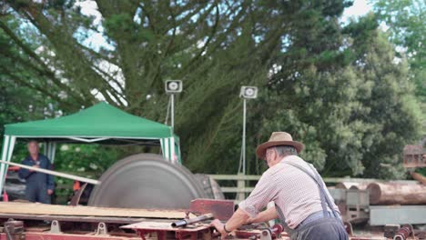 Lumberjack-At-Work---Cutting-Tree-Log-On-A-Wood-Sawmill-Machine-In-The-Forest---medium-shot