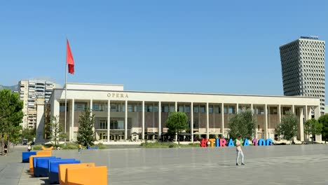 People-walking-in-front-of-the-Albanian-Opera-House