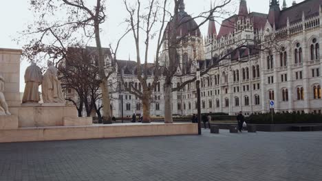 POV-tram-ride-through-Budapest-passing-by-Parliament-and-monuments-outside-it-in-Hungary