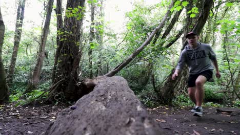 Young-male-athlete-jogging-in-forest