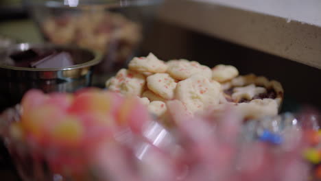 Slider-shot-of-multiple-chocolates,-cookies-and-candies-on-a-table