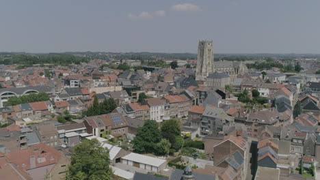 AERIAL:-A-city-with-its-church-dominating-the-view-on-a-beautiful,-summer-day