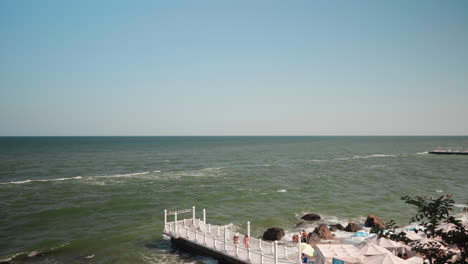 Two-women-walking-on-white-pier