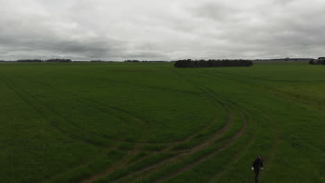 Aerial-over-top-of-tractor---people-working-in-farmland-area