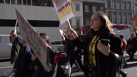 UK-February---Students-holding-placards-on-a-climate-change-protest-march-along-a-street