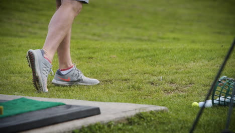 Close-up-of-a-golfer-teeing-off-on-the-driving-range-in-slow-motion