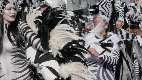 Close-up-of-woman-marching-and-dancing-dressed-in-zebra-costumes-in-the-African-themed-parade-at-the-Paphos-Carnival