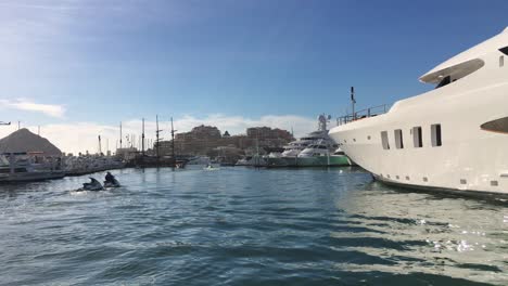 Pirate-Ship,-Boats-and-Jet-Skis-Moving-Through-the-Marina-Cabo-San-Lucas-in-the-Morning