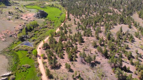 Aerial-view-tracks-UTVs-down-a-trail