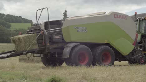 Tractor-in-hay-fields-pulling-a-baler