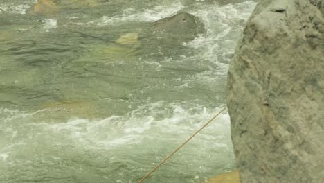 A-mountaineering-institute-trainee-crossing-a-mountainous-river-with-Single-wading-technique