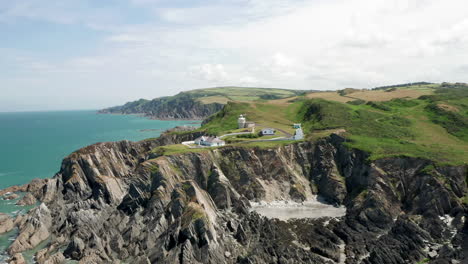 Clockwise-Aerial-Orbit-of-a-Lighthouse-Perched-above-a-Rocky-Coastline