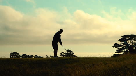 Silhouetted-golfer-swinging-his-club-at-Bandon-Dunes-Golf-resort