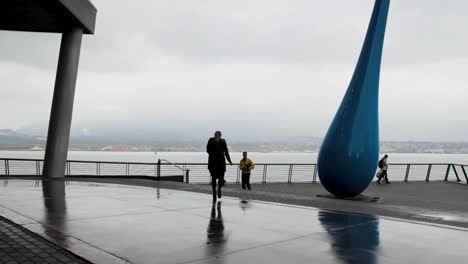 Pedestrian-meeting-someone-on-a-city's-harbour-front