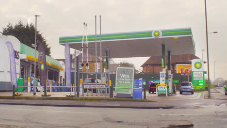 Gasolinera-Y-Tienda-De-Conveniencia-Con-Una-Clienta-Corriendo-Hacia-Su-Auto