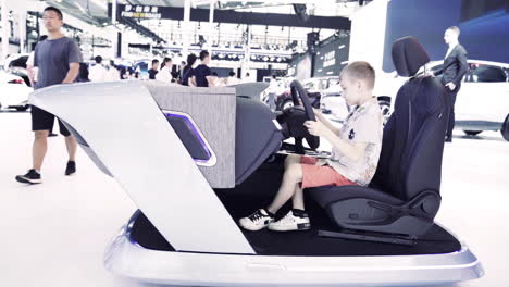 A-kid-is-playing-with-a-Car-Imitator-at-2019-International-Auto-Show-in-Shenzhen,-China