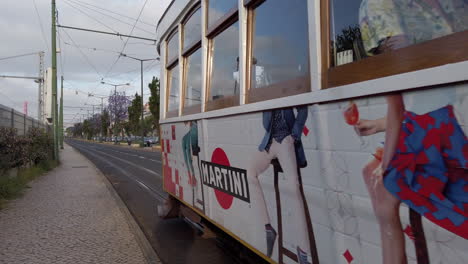 Lisbon-yellow-electric-train-pass-by-in-a-beautiful-morning