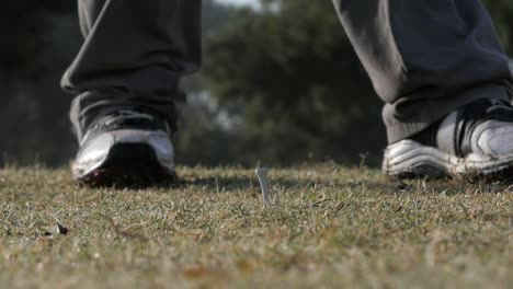 Amateur-golfer-teeing-off-in-a-round-of-golf,-close-up-and-slow-motion