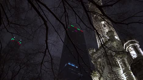 John-Hancock-Center-And-The-Old-Water-Tower-Palace-In-Chicago-during-a-winter-night-4k