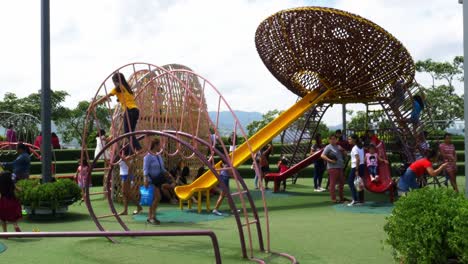 Supervised-by-parents-and-guardians,-frolicking-young-kids-explore-the-playground-attractions-at-SM-Seaside-Mall-on-South-Road-Properties,-Cebu-City,-Philippines