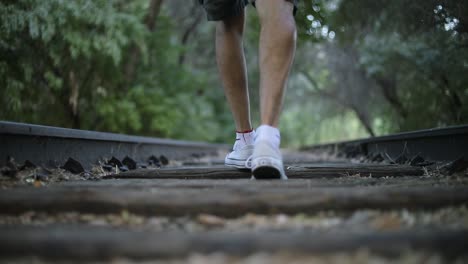 Toma-En-Cámara-Lenta-De-Alguien-Caminando-Sobre-Vías-De-Tren-Abandonadas