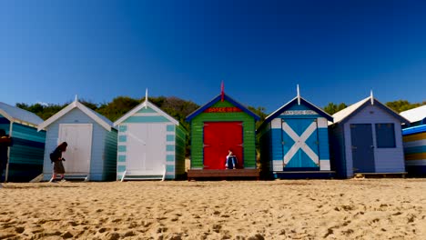 Mädchen-Liest-Buch-In-Brighton-Bathing-Boxes,-Melbourne,-Australien.-Bringon-Bathing-Boxes,-Melbourne