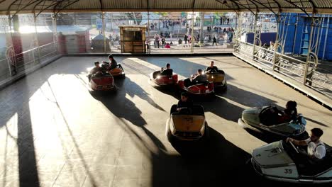 children-and-teenagers-playing-in-electric-bumper-cars-in-amusement-park-on-a-sunny-day-in-montevideo-uruguay-4K-video