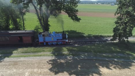 Aerial-View-of-a-Thomas-the-Tank-Engine-with-Passenger-Cars-Puffing-along-Amish-Countryside