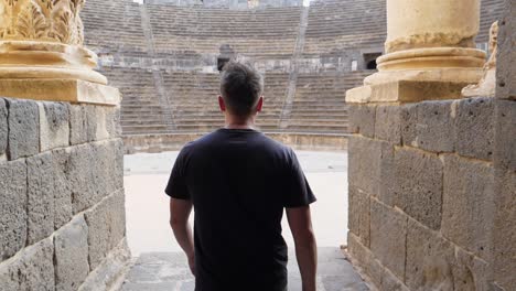 Slow-motion-moving-forward,-man-in-black-walking-to-the-stadium-in-Syria-Damascus