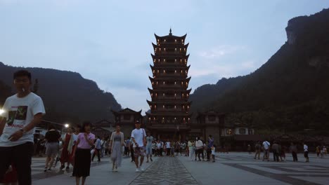 Wulingyuan,-China---August-2019-:-Crowds-of-people-leaving-the-Wulingyuan-exit-to-the-Zhangjiajie-national-park-in-the-evening,-Hunan-Province